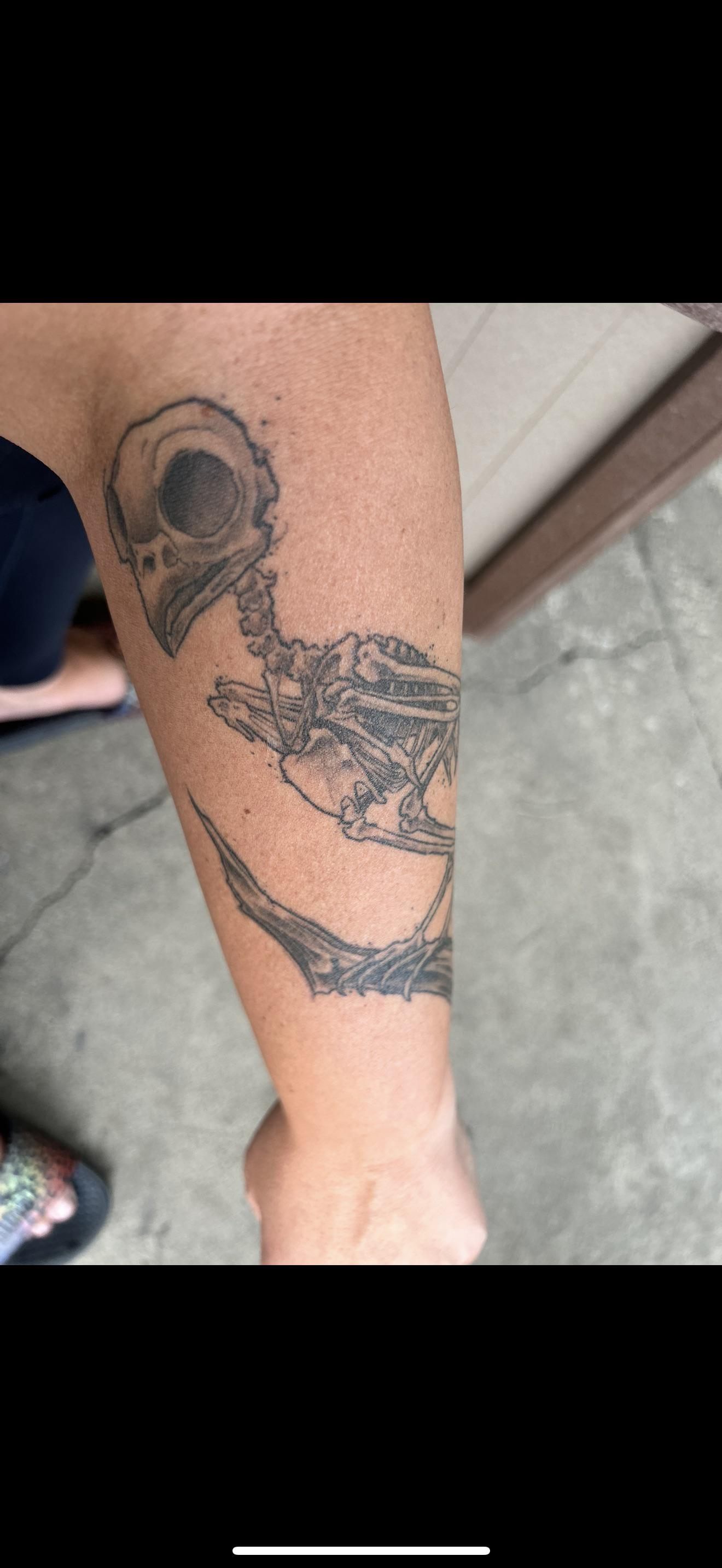 Skeletal artistry meets automotive passion in this striking leg piece that transforms bone into chrome and sinew into steel. The seamless fusion of skull anatomy with engine components creates a mesmerizing biomechanical narrative, where death and horsepower intertwine in perfect black-and-gray harmony. 💀⚙️
