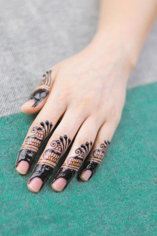 Intricate henna artistry transforms fingertips into miniature masterpieces, with each digit showcasing delicate mandala-inspired patterns that flow from nail to knuckle. The rich, dark brown designs create stunning contrast against skin, featuring ornate scrollwork and geometric details that make this temporary body art feel like wearable jewelry ✨