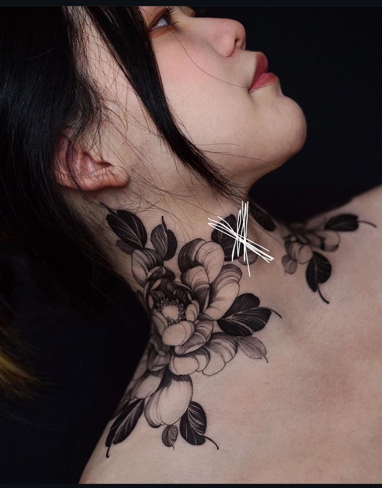 Botanical elegance meets modern artistry in this stunning neck piece, where delicate peonies cascade gracefully along the shoulder and collarbone. The soft shading and intricate linework create dimensional petals that seem to bloom directly from the skin, while the strategic placement follows the natural curves of the body for maximum visual impact. 🌸