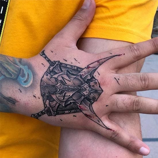 Brilliant optical illusion artistry transforms this palm into a window revealing intricate mechanical gears beneath the skin. The detailed linework and strategic placement across the natural creases creates an incredibly convincing