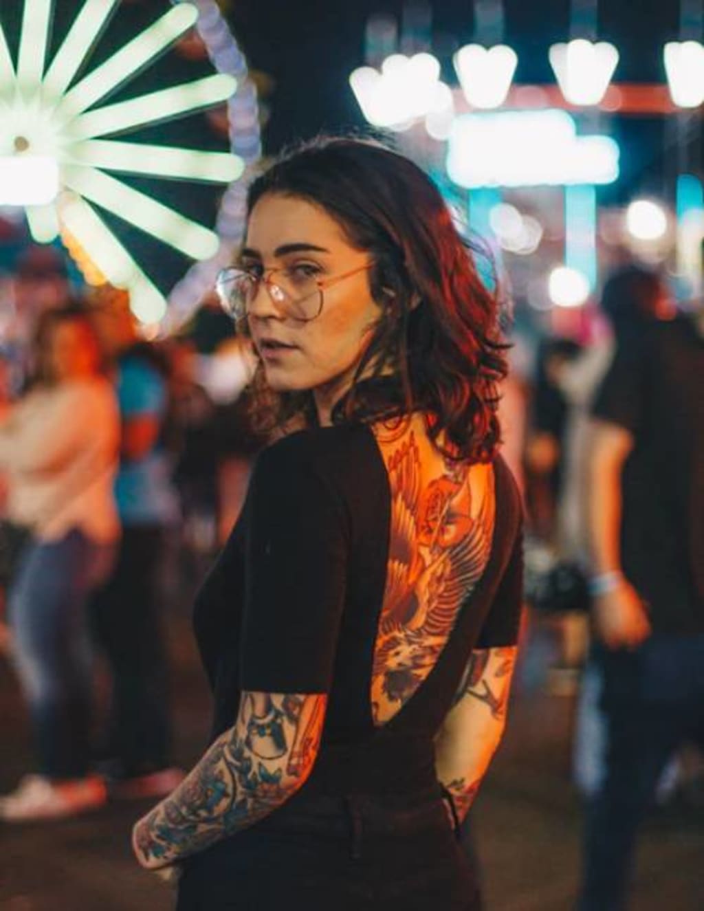 Vibrant orange flames dance across this stunning sleeve, creating a mesmerizing contrast against the night's neon backdrop. The intricate fire design seems to glow with its own inner light, perfectly complemented by detailed ink work that flows seamlessly from shoulder to forearm. 🔥 A bold statement piece that transforms the arm into a canvas of living art.