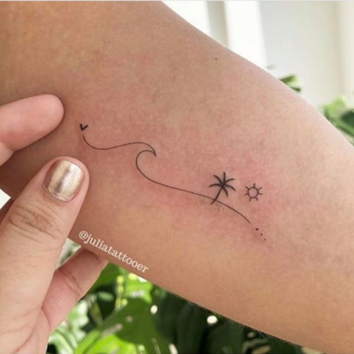 Wanderlust meets minimalism in this delicate fine-line design that captures an entire vacation story in just a few elegant strokes. The flowing path connects a soaring bird to tropical paradise symbols—a palm tree and radiant sun—creating a beautiful narrative of freedom and adventure that wraps gracefully around the arm. ✈️🌴