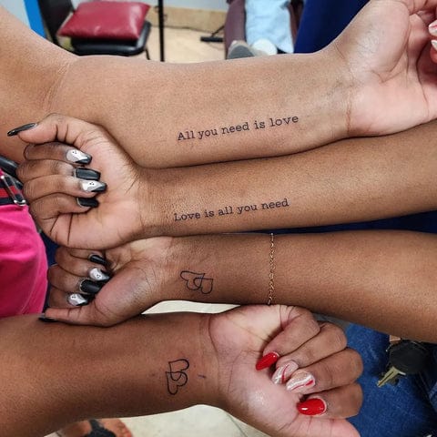 Four arms intertwined tell a beautiful story of connection through matching Beatles-inspired ink.