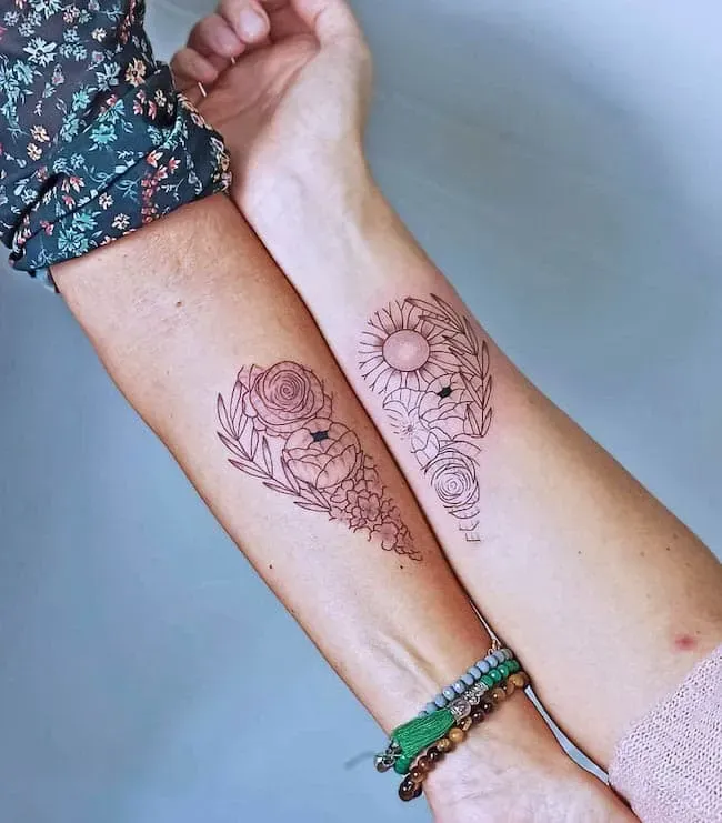 Delicate line work blooms across these complementary forearms, creating a stunning botanical symphony that celebrates both celestial and earthly beauty. The left arm showcases roses intertwined with geometric patterns, while the right features a radiant sunflower paired with classic roses—a perfect balance of structured design and organic flow. These matching yet distinct pieces prove that couple tattoos can honor individuality while creating visual harmony ✨