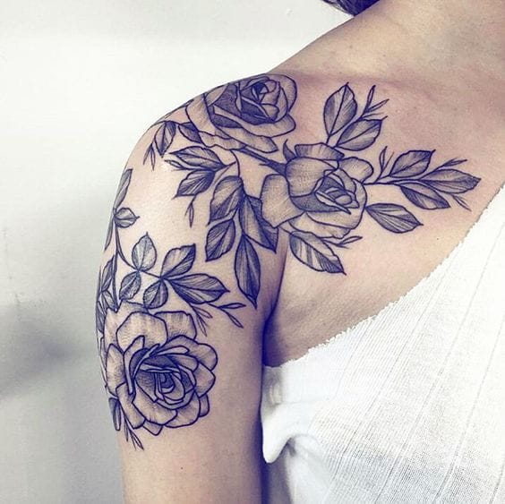 Delicate linework transforms this shoulder into a blooming garden, where roses and leafy vines cascade naturally along the arm's curves. The monochromatic design creates stunning contrast against skin, with each petal and leaf rendered in exquisite detail that feels both timeless and romantic 🌹