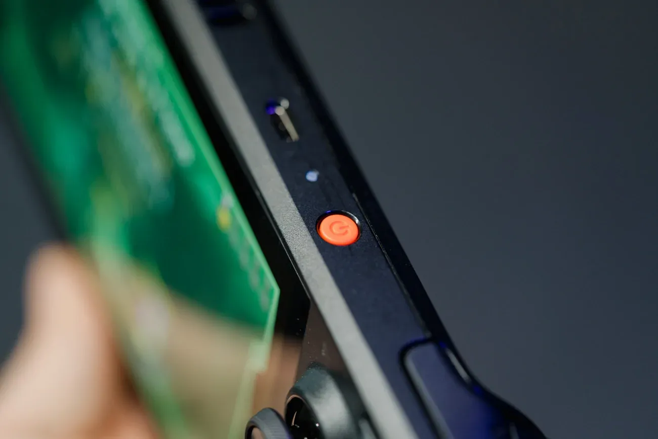 Shot of the orange power button of the Steam Deck OLED.
