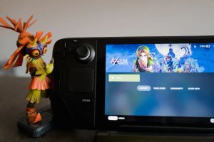 A Majora's Mask figurine standing next to a Steam Deck