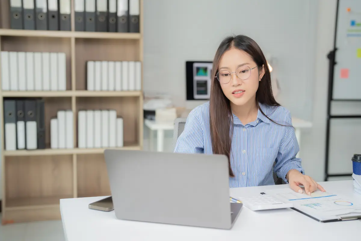 woman looking at laptop - How to Dissolve an LLC in Georgia