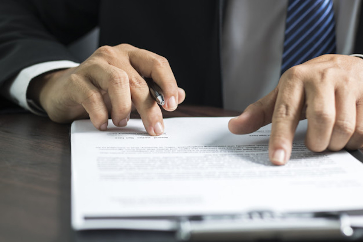 person looking at document - How To Dissolve An LLC In Oklahoma