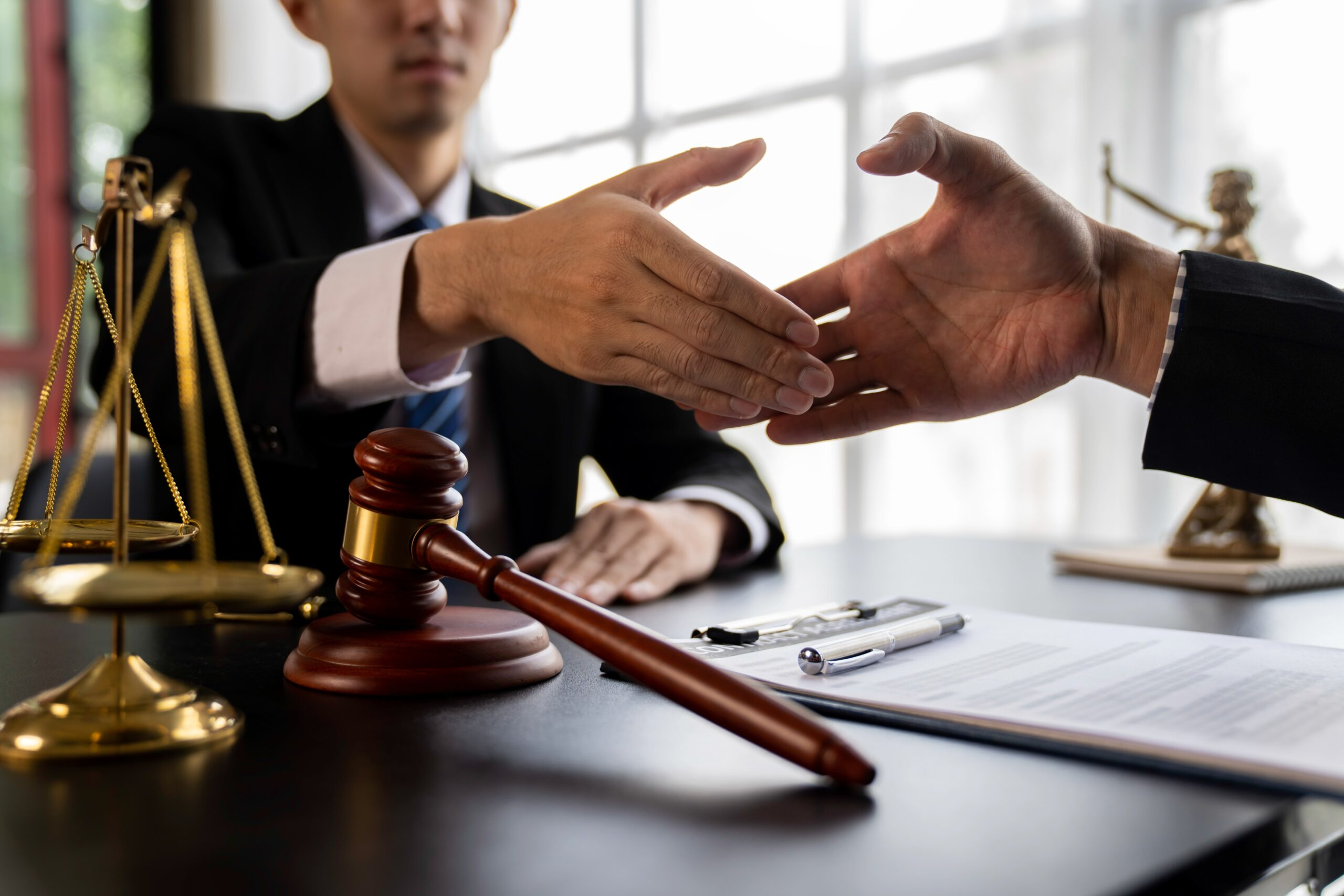 Shaking hands - How To Dissolve An LLC In Oklahoma