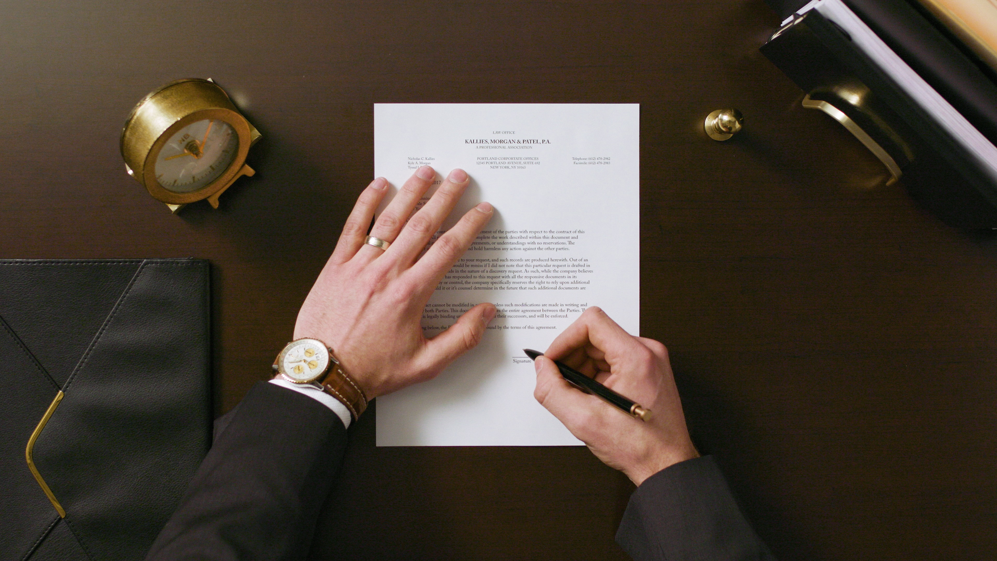 man signing a document - How to Dissolve an LLC in North Carolina