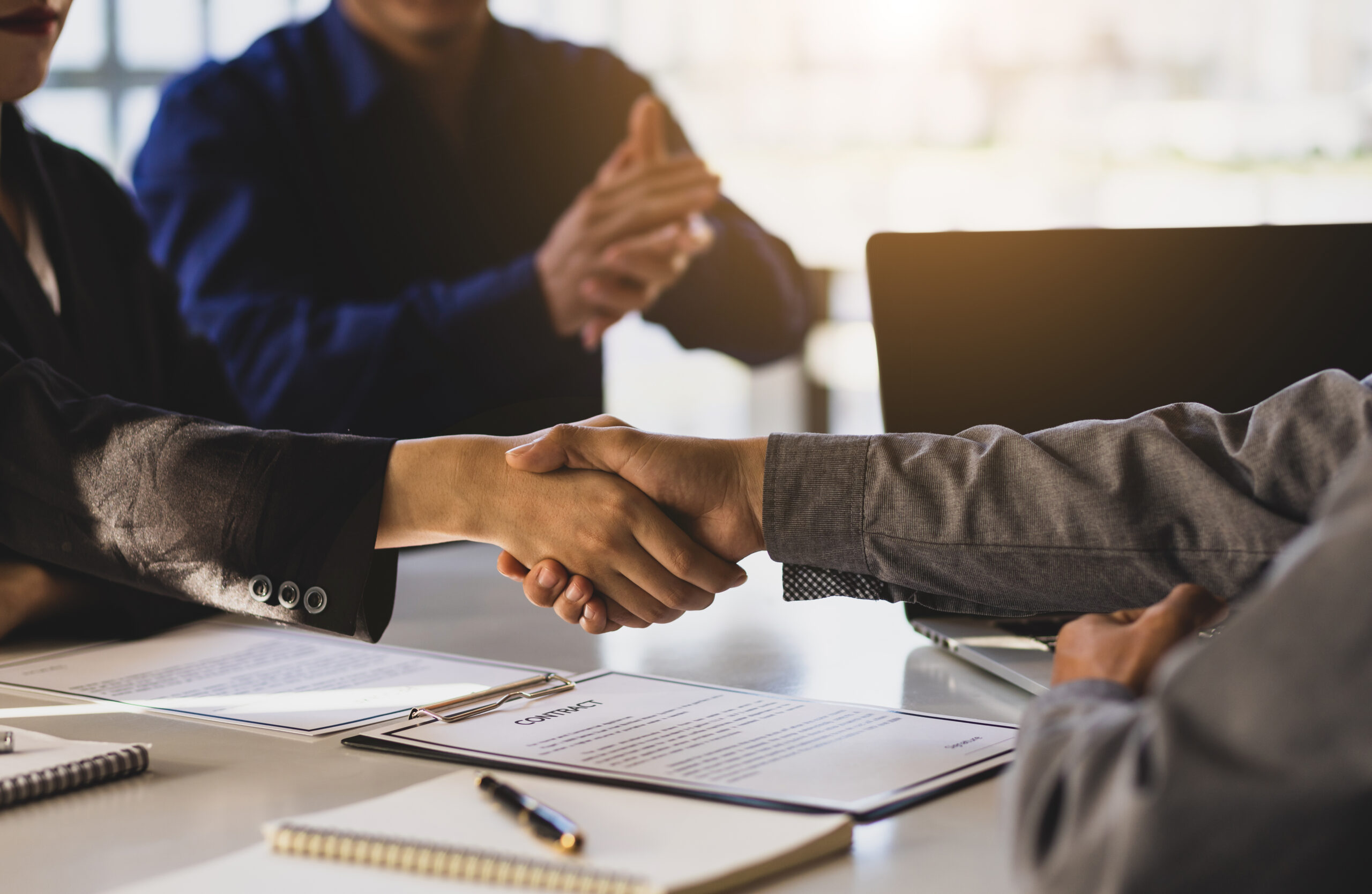 man shaking hands - How to Dissolve an LLC in New York