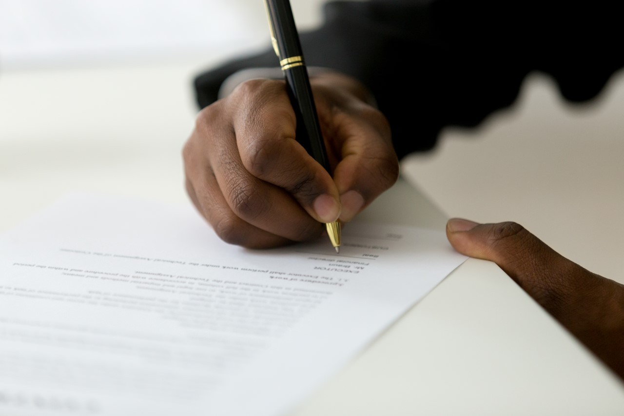 man signing - How to Dissolve an LLC in Indiana 