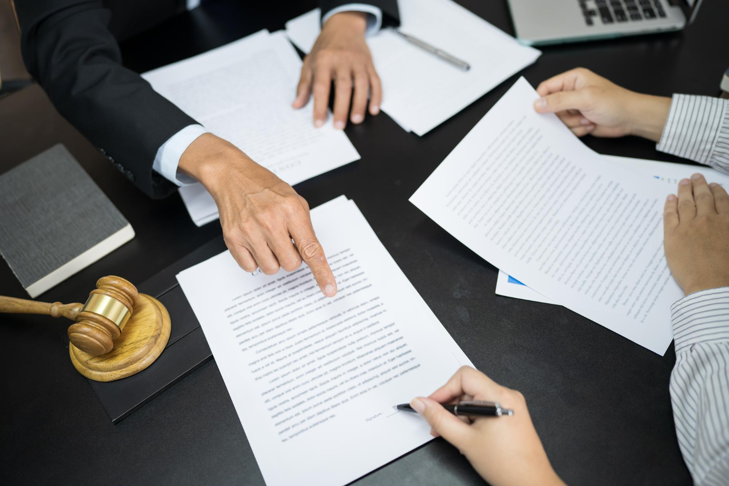 signing a legal document - How to Dissolve an LLC in Arkansas