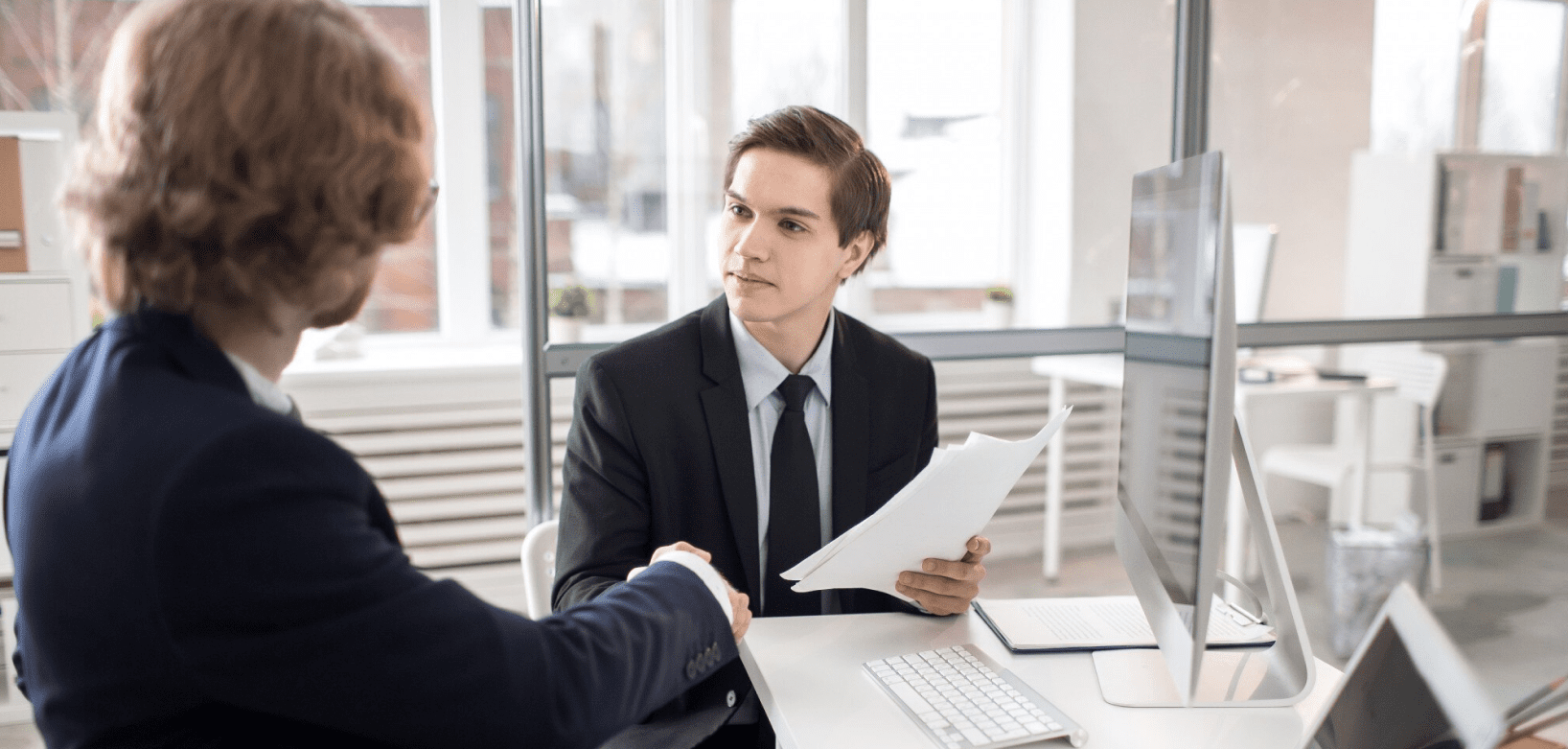 person holding documents - How to Dissolve an LLC in Arkansas