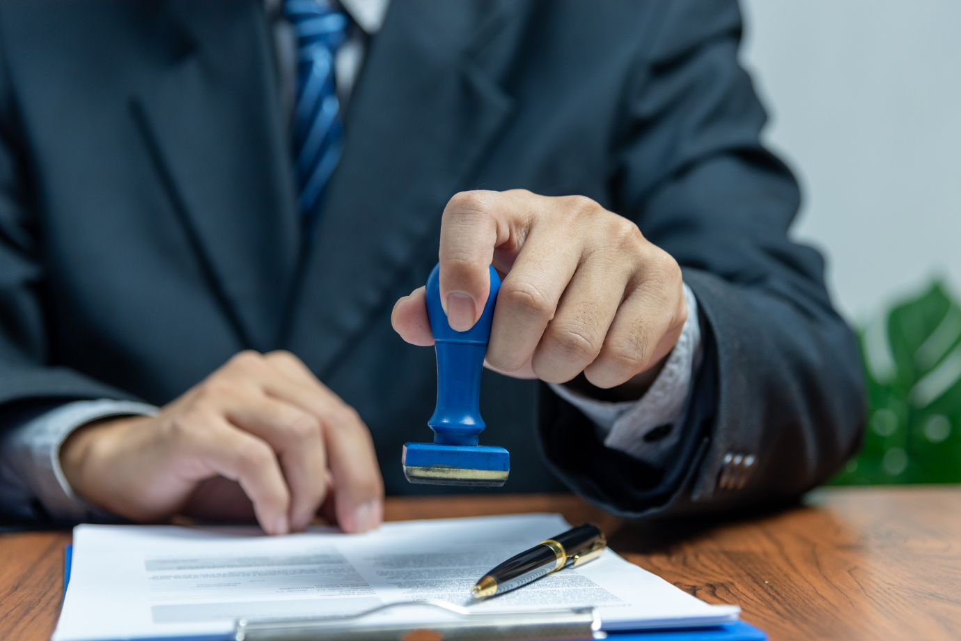 man using a stamp - How to Dissolve an LLC in Tennessee