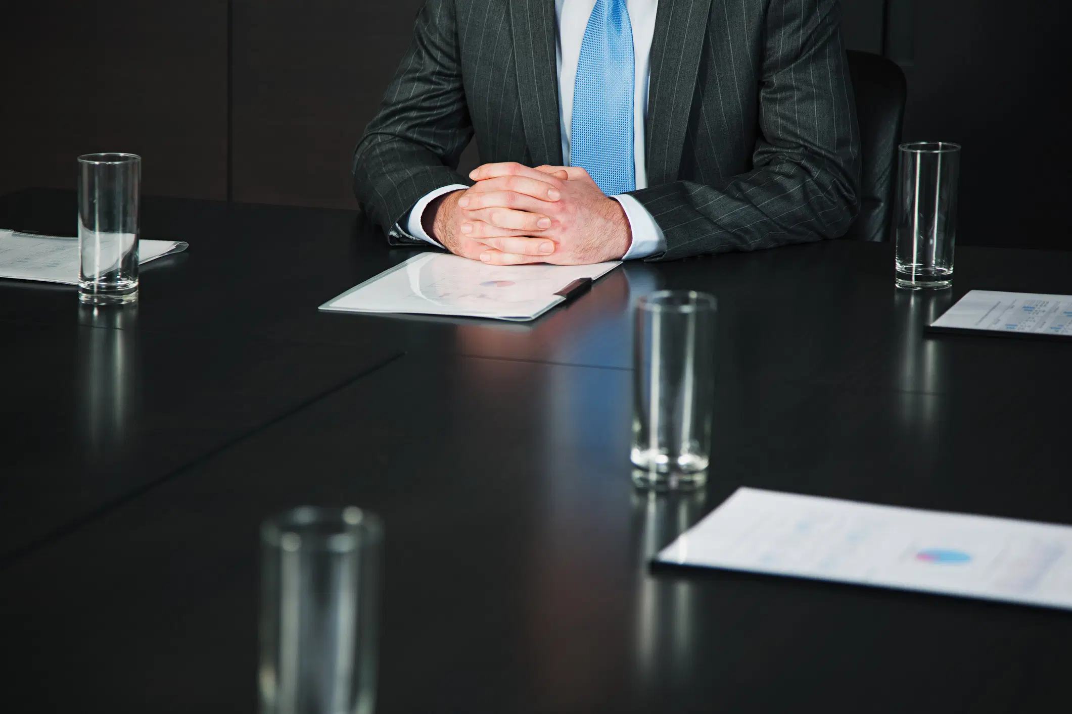 man sitting in a meeting - How to Dissolve an LLC in Colorado