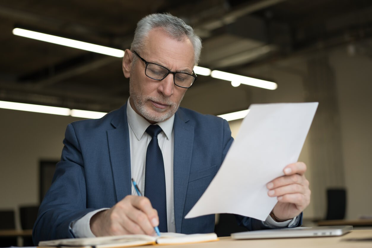 person reading documents - How to Dissolve an LLC in Colorado