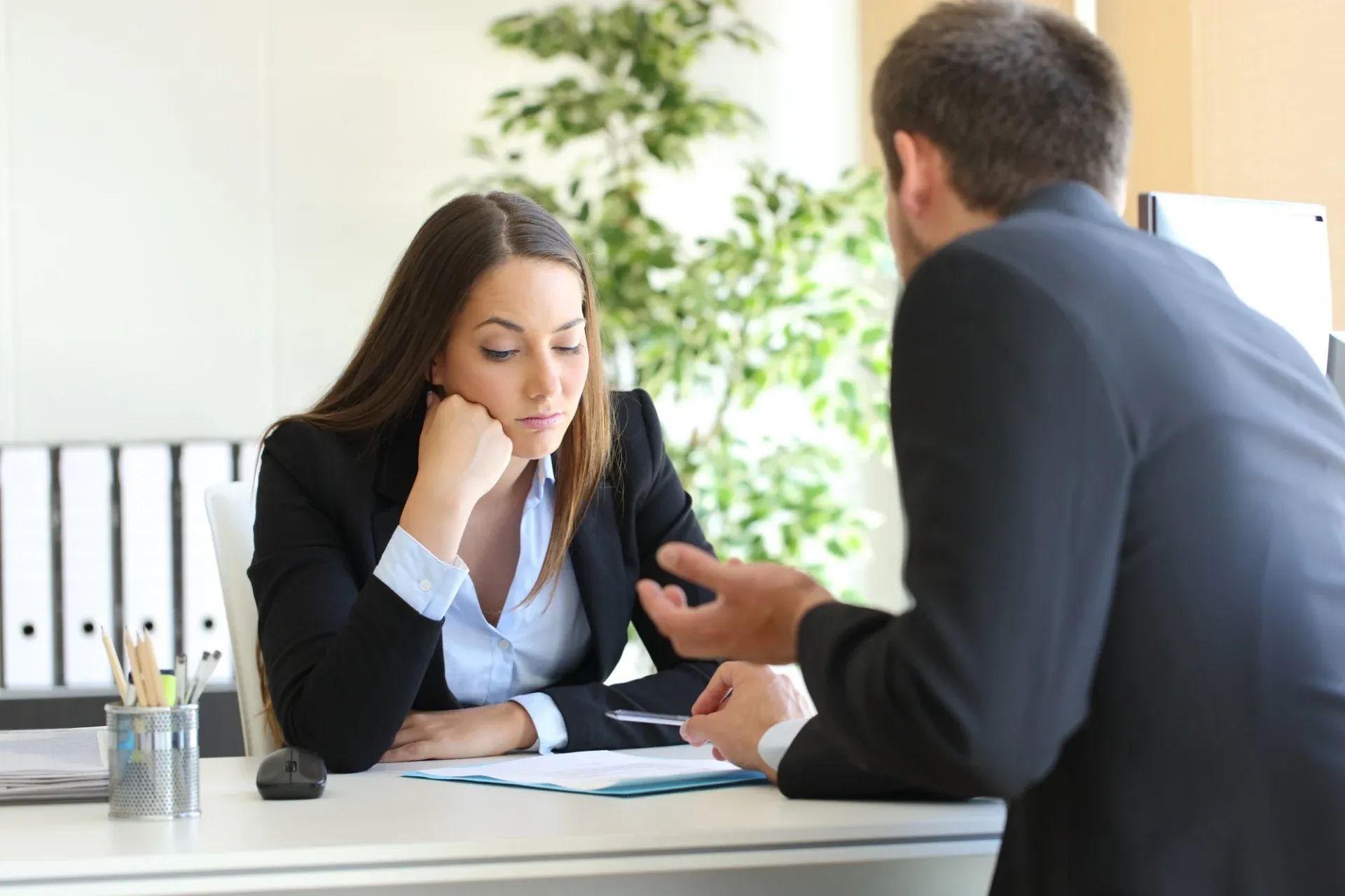 woman in a serious meeting - How to Dissolve an LLC in North Carolina