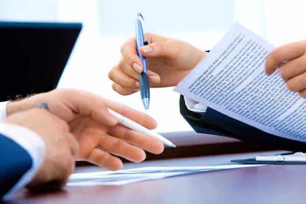 signing a document - How To Dissolve An LLC In Texas