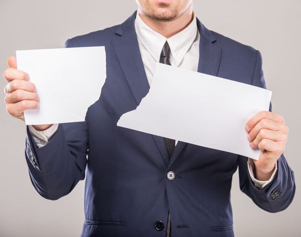 Person Tearing Paper - How to Dissolve a Corporation in Nevada