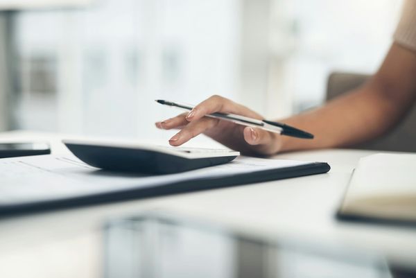 woman calculating taxes - Close Corporation Taxation