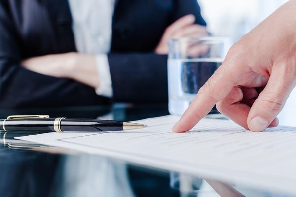 man pointing on a document - How Much Does It Cost To Close An LLC