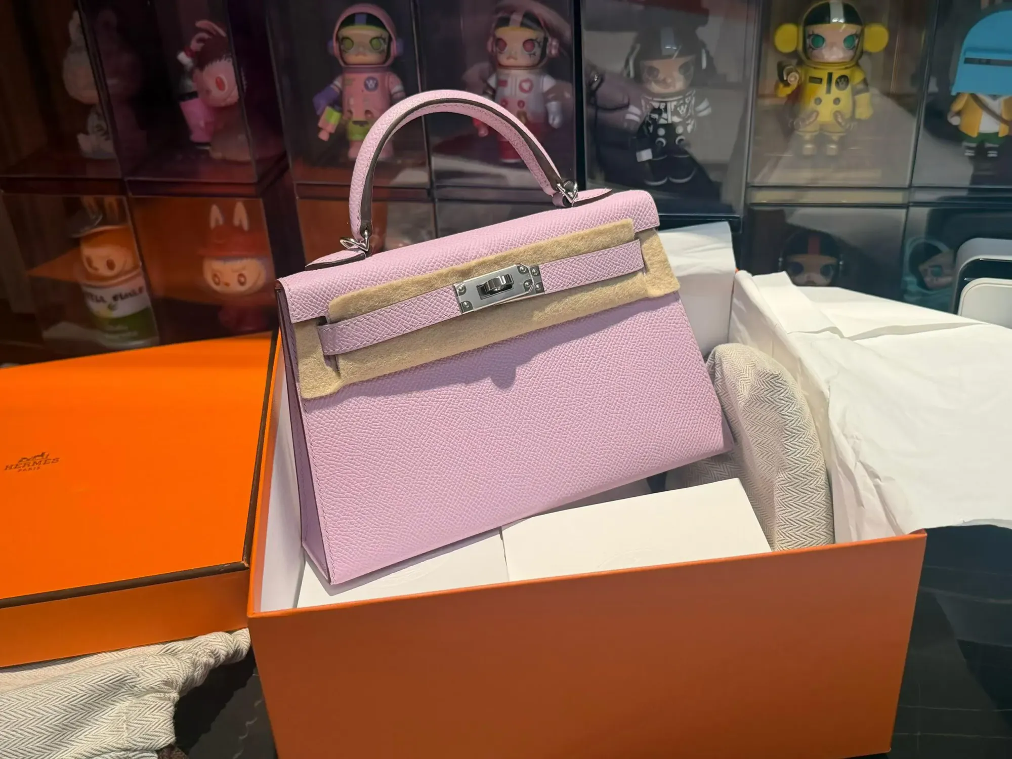 Hermès Mini Kelly II Guimauve(棉花糖粉)實物圖片。Guimauve屬Hermès 2026年度備受關注嘅新色之一,呈現帶粉紫底調嘅柔和粉色效果,於不同光線下可展現由淡粉至微紫色調嘅變化,整體觀感輕盈而具層次感。