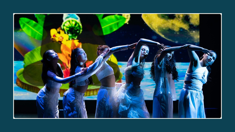 Photo credit: Robbie Sweeny Image ID: Photograph of six dancers in flowing white outfits standing in a line connecting their arms to make a curving wave. 