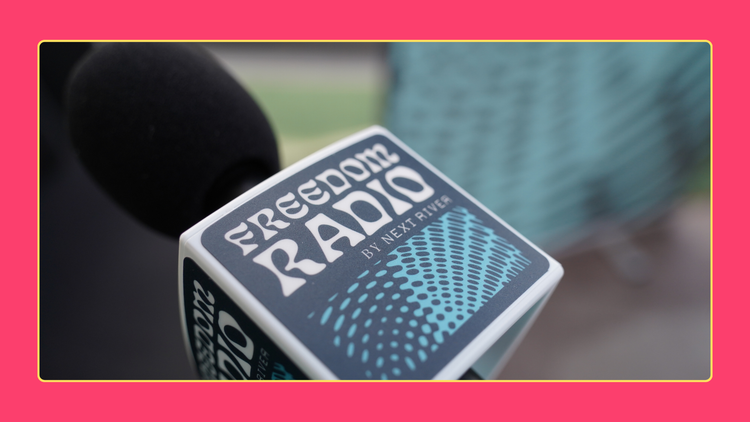 Photo of microphone with Freedom Radio microphone flag.
