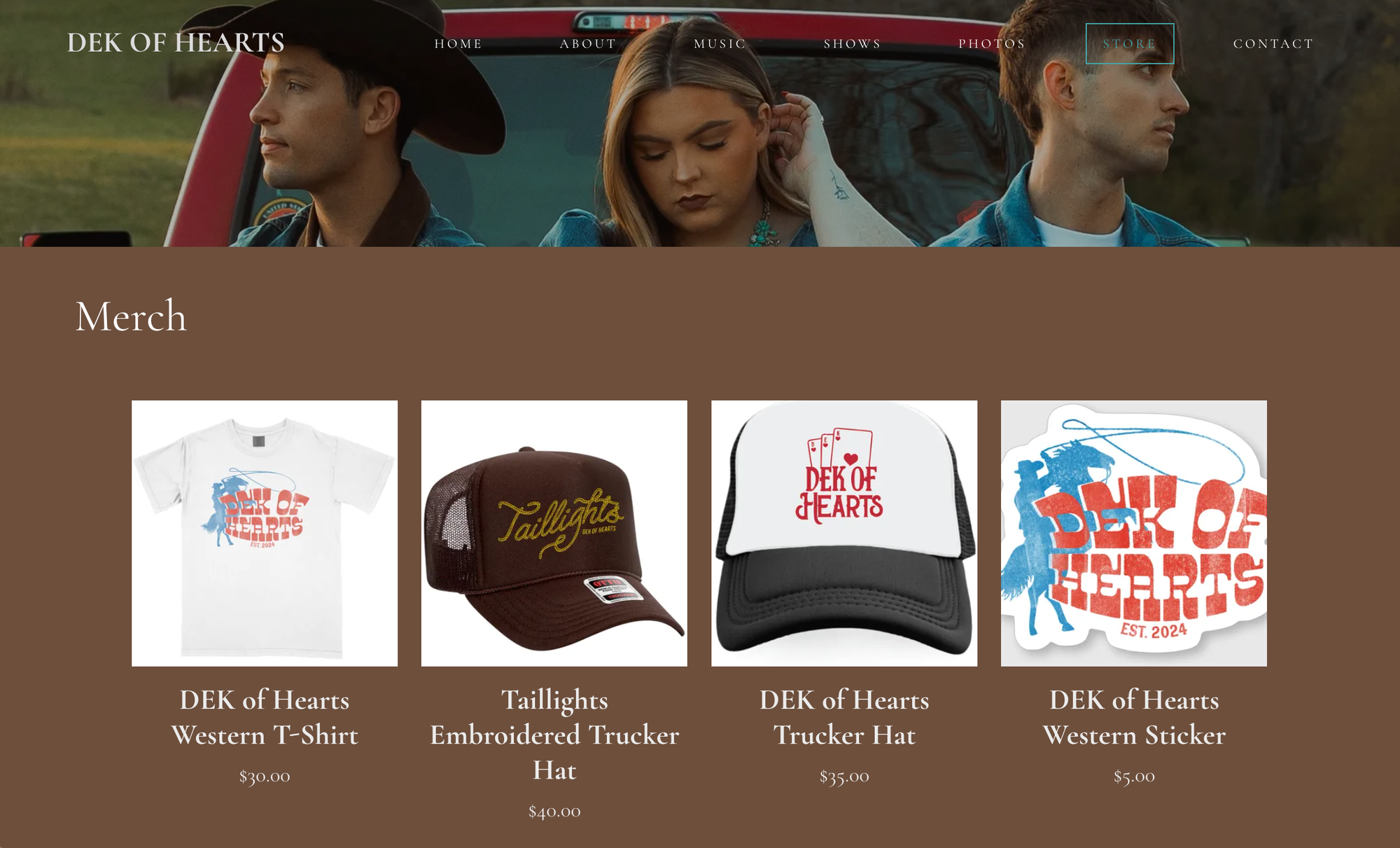 Bandzoogle blog: 5 best merch products to sell as a musician. Image shows the merch table from artist DEK of Hearts's website.