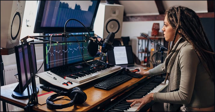 woman producing music in a home studio