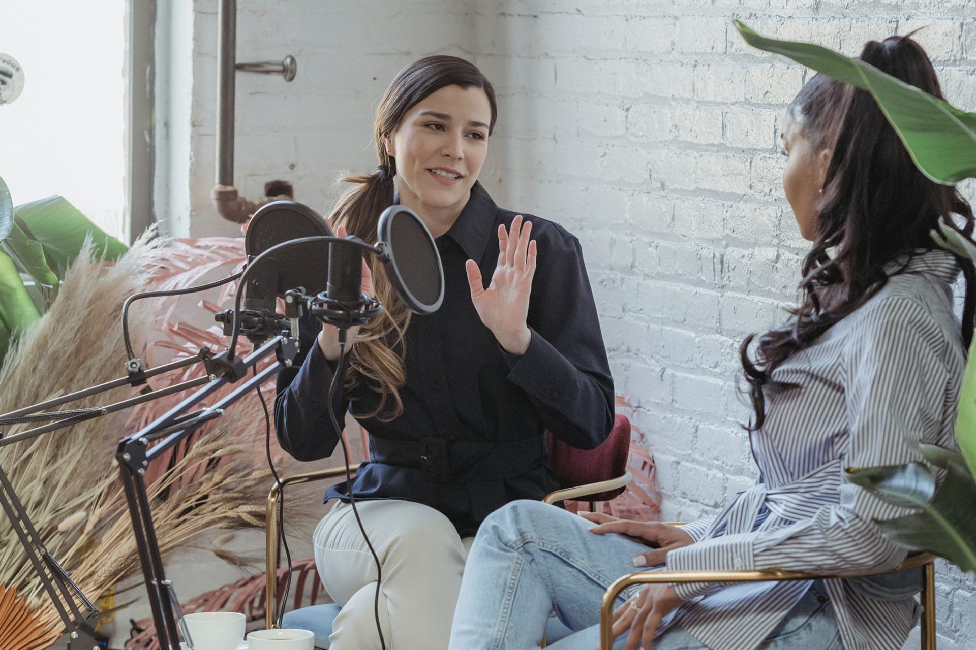 two women talking on a microphone