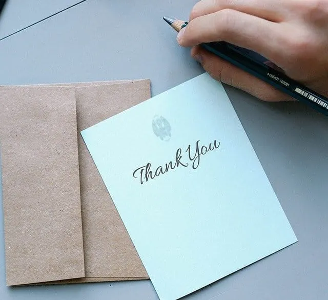 Thank You handwritten note with a pen on a desk, expressing appreciation, in a professional and elegant style suitable for bu
