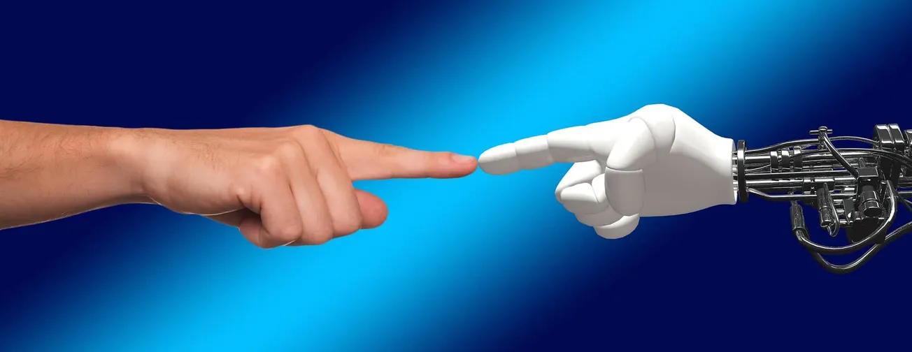 Fingers touching between human hand and robot hand symbolizing AI and technology interaction.