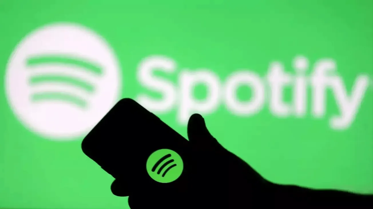 Spotify music streaming app on smartphone with green background and logo, digital music service, music streaming, online musi