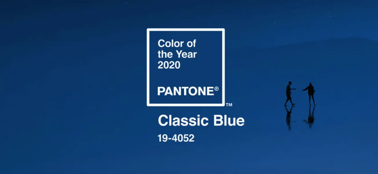 Vivid classic blue background with two silhouetted people walking and shaking hands, representing the Pantone Color of the Ye