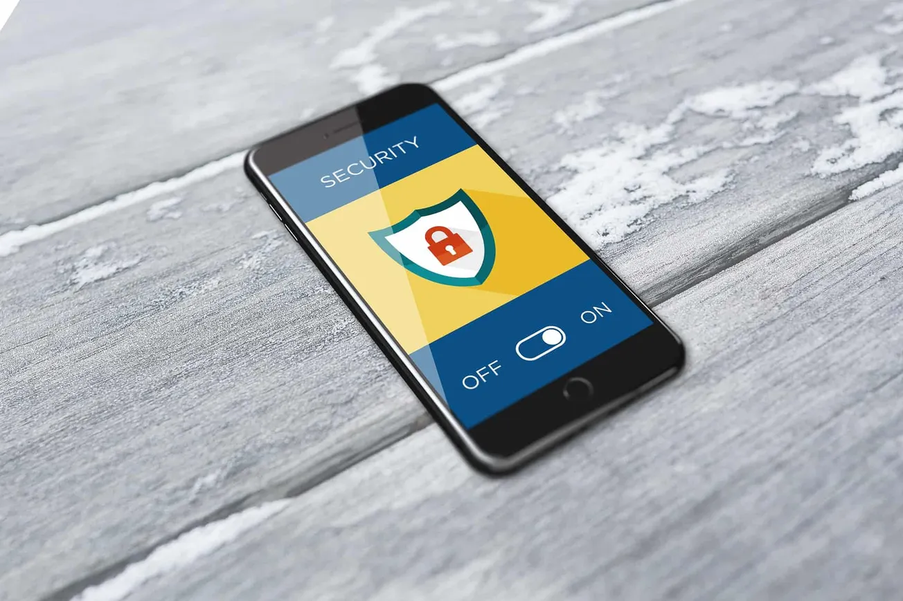 Secure mobile phone with security shield icon and toggle switch on screen, concept of digital security, online security, data
