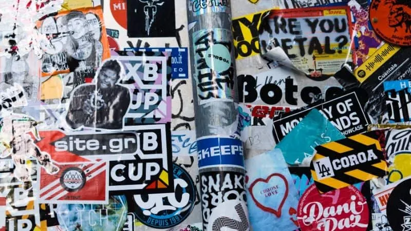 Colorful collage of various stickers, street art, and graffiti from Hypebot website, showcasing urban culture, music scene, a