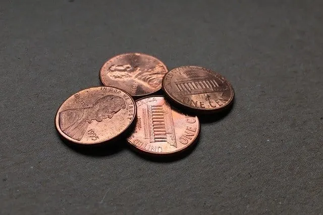 Pennies on dark surface, close-up photo of U.S. one-cent coins, copper pennies with Lincoln faces, used in financial or monet