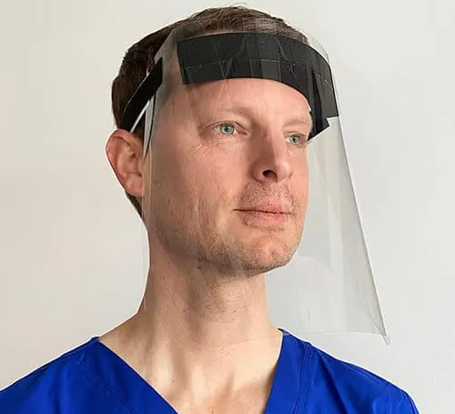 Face of a man wearing a protective face shield, medical professional, PPE safety gear, healthcare worker, virus prevention, h