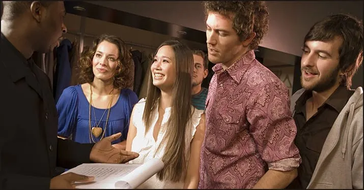 Band of diverse young people listening attentively during a discussion or presentation in a casual setting, emphasizing music