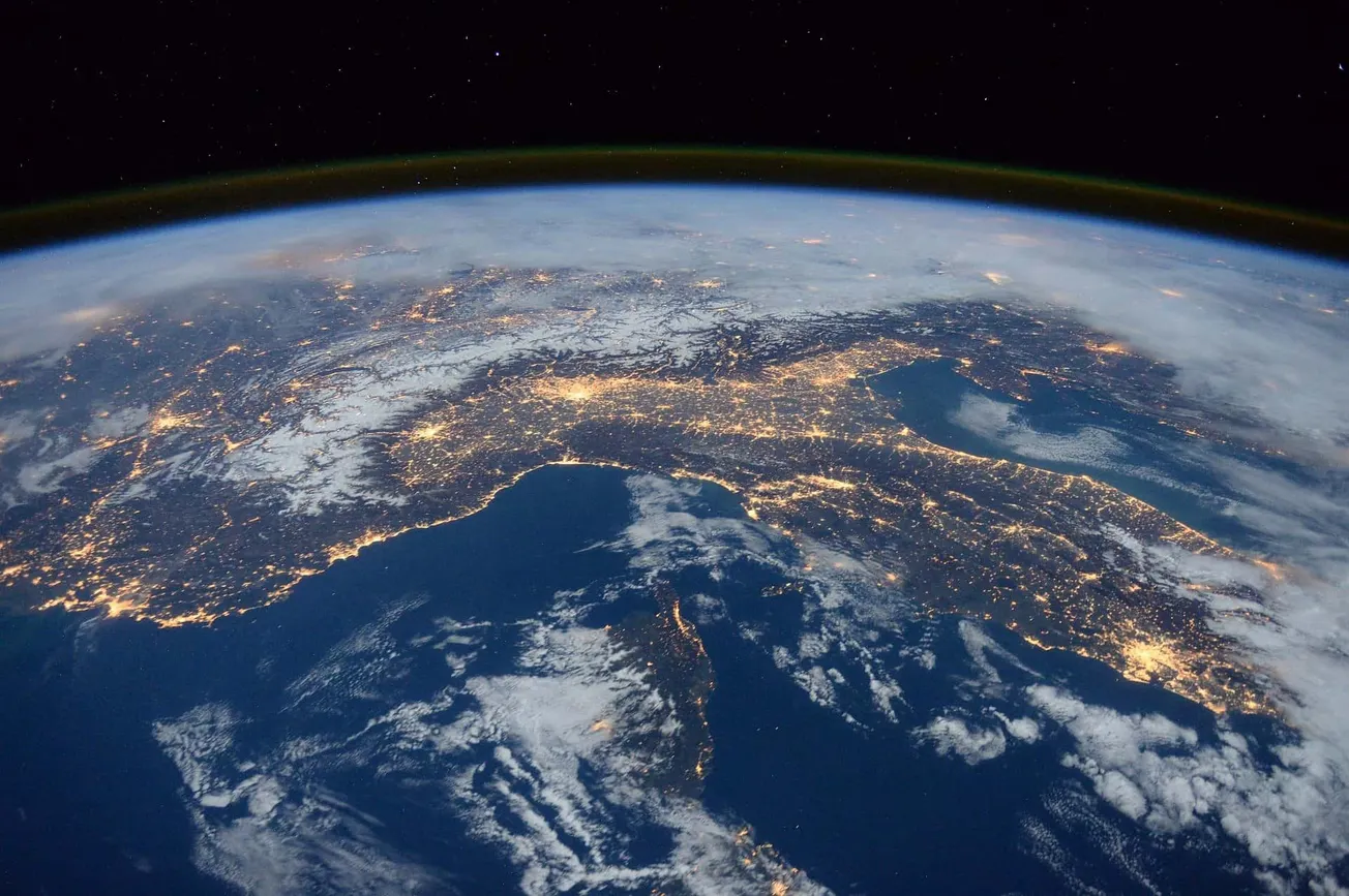 Vibrant view of Earth from space showing illuminated landmasses and the night sky with stars, highlighting global connectivit