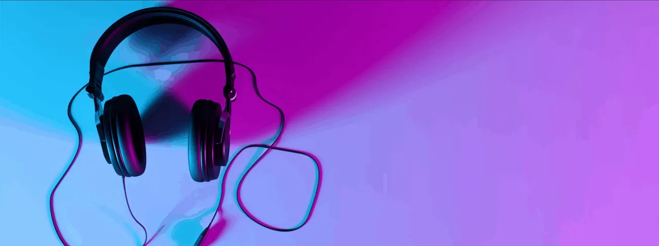 Headphones on a vibrant, colorful background with gradient shades of blue, purple, and pink, perfect for music, audio, and en