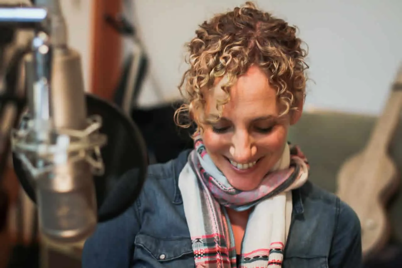 Creative woman recording music in a professional studio, emphasizing music production, vocal recording, and audio quality, wi