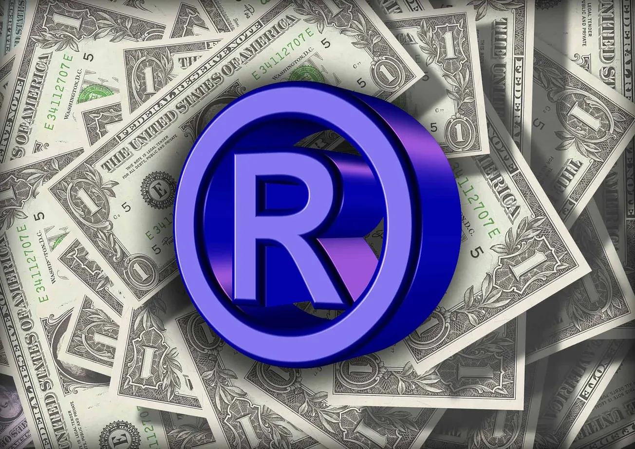 Registered trademark symbol on dollar bills, representing monetization and branding in the music industry.