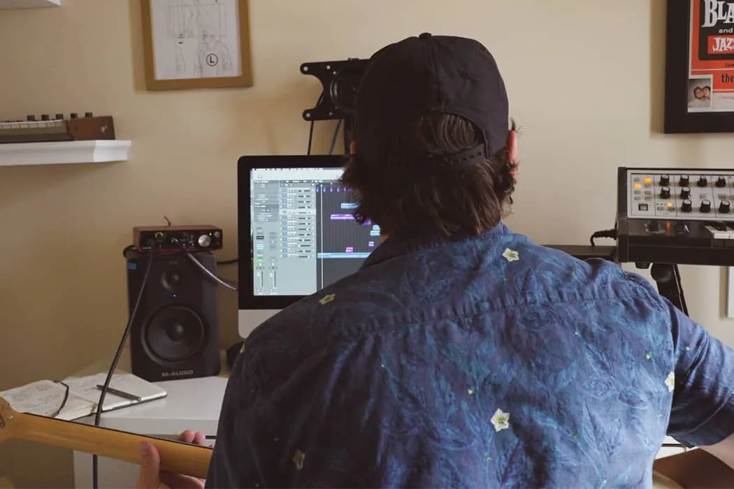 Music producer working on digital audio workstation in home studio, music creation, mixing, producing, beatmaking, music tech