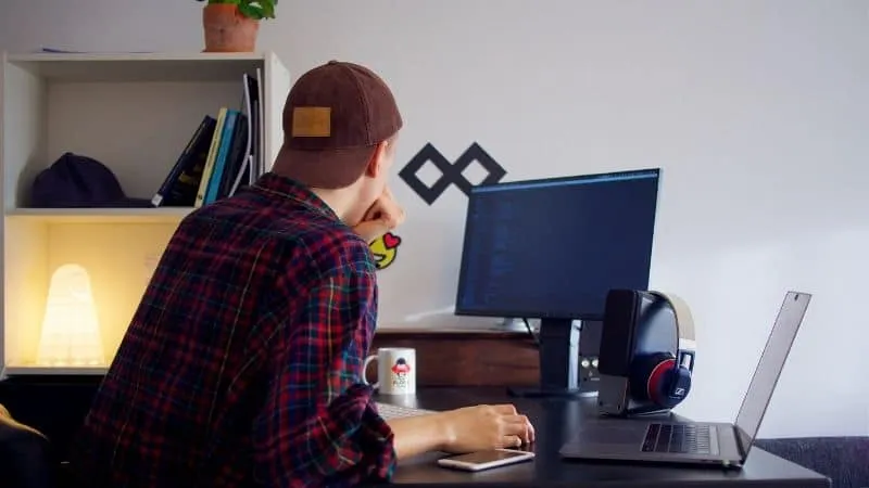 Innovative digital marketing workspace with a young person working at a desk featuring a large monitor, laptop, and headphone