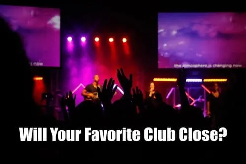 Bright concert stage with performers and colorful lighting, highlighting a lively music event at a nightclub or concert venue