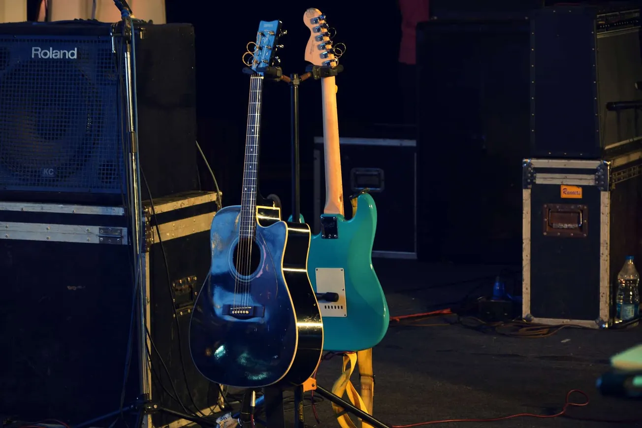 Guitar setup on stage with amplifiers and equipment for live music performance.